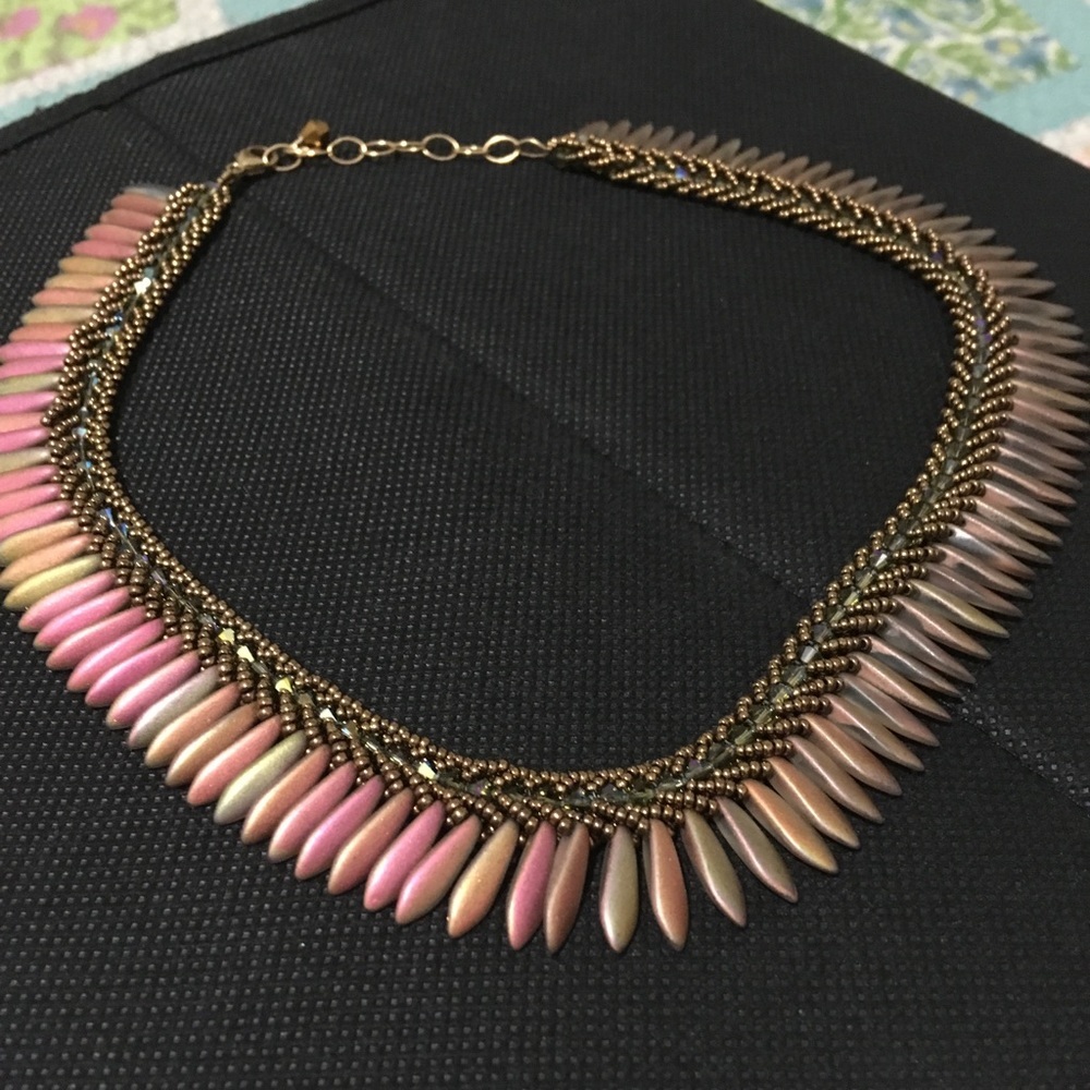 Copper colored bead necklace with feather beads